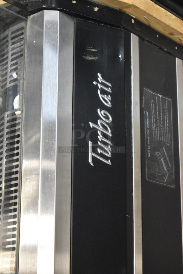 Turbo Air TOM-40MB open merchandiser, metal finish, visible scratches, 115V, with "Turbo Air" logo and instructional label.
