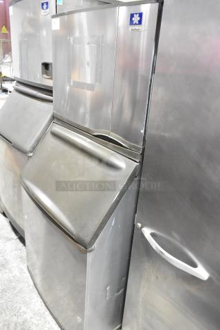 Manitowoc SY0504A stainless steel ice head on B570 bin, 115 volts, 1 phase. Good condition, visible branding.