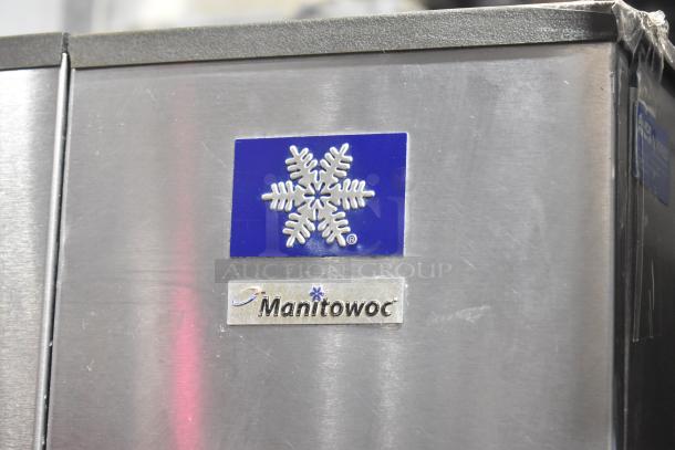 Manitowoc SY0504A ice maker, stainless steel, on B570 bin. 115V, 1 phase. Features snowflake logo, commercial condition.
