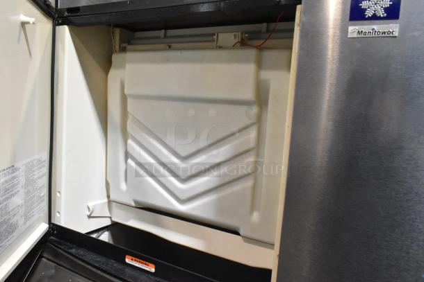 "Manitowoc SY0504A stainless steel ice head on B570 bin, 115V, 1 Phase, in good condition with visible controls and caution label."