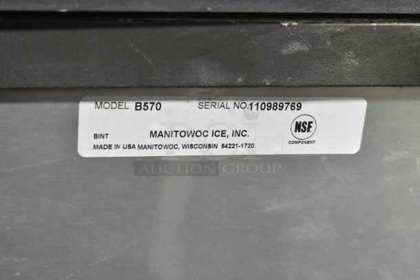 Manitowoc SY0504A stainless ice head and B570 bin. 115V, 1 phase. Label shows model B570, serial 110989769, NSF certified.