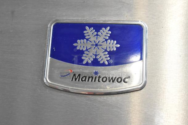 Manitowoc stainless steel ice machine logo on commercial unit, featuring snowflake design.