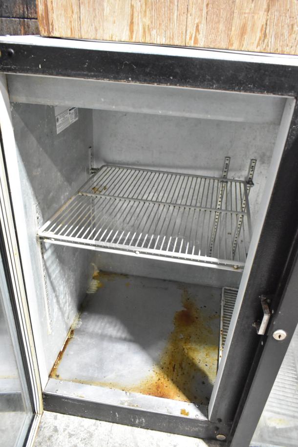 Beverage Air BB48GY-1-B commercial 2-door back bar cooler, visible wear and rust, open doors, 115V, metal interior shelves.