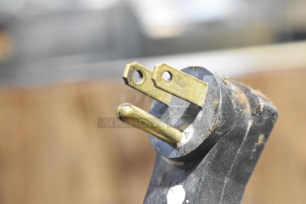 Power plug of Beverage Air BB48GY-1-B cooler, showing a standard 115 volts connector with slight wear.