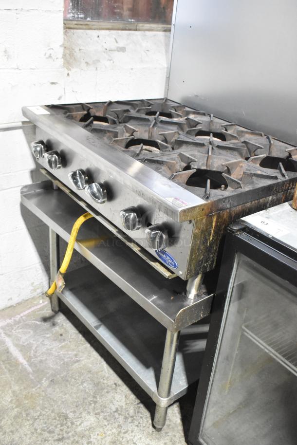 Cook Rite stainless steel 6-burner countertop gas range on equipment stand, featuring control knobs, used condition.