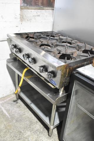 Cook Rite stainless steel 6-burner countertop gas range on equipment stand, featuring control knobs, used condition.