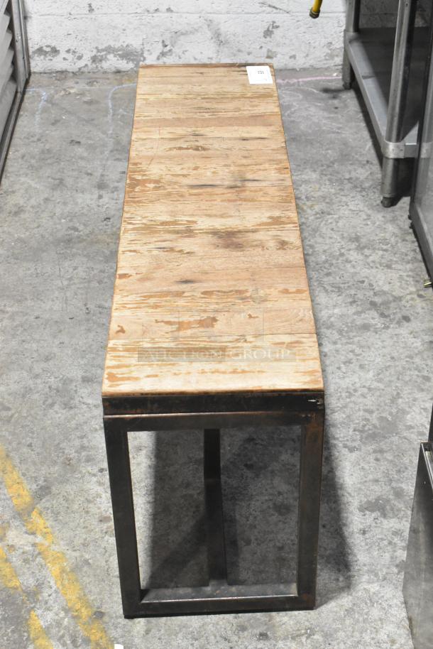 Wooden over shelf with metal frame, industrial style, visible wear, rectangular table top, tag on surface.