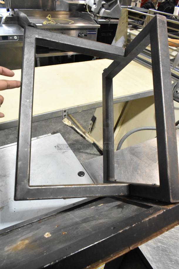 Metal over shelf frame, rectangular shape, industrial design, minor wear, suitable for kitchen or workshop use.