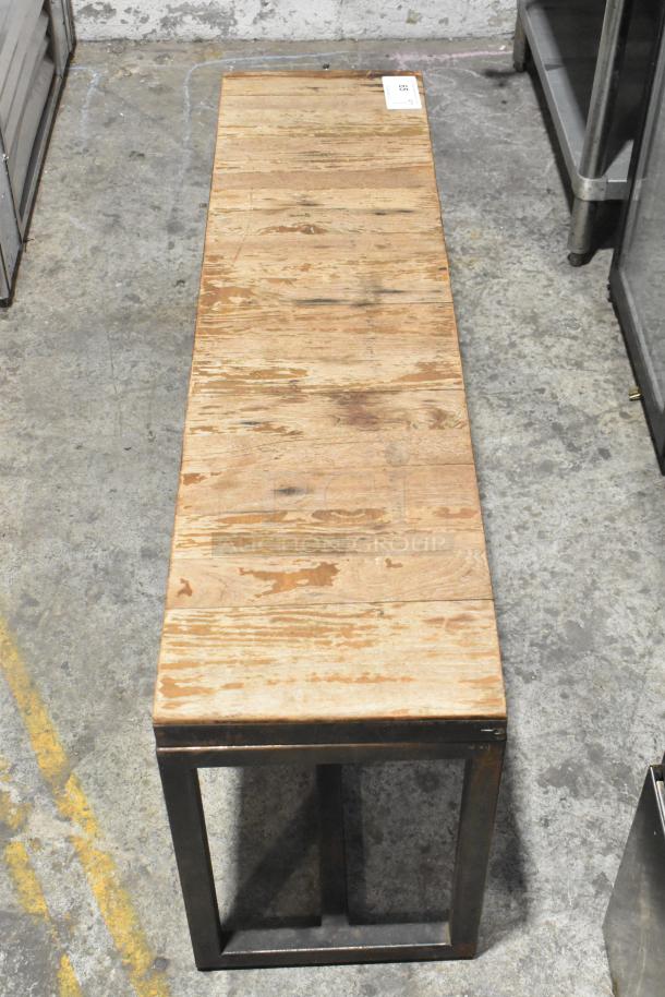 Wooden over shelf with metal frame, showing natural wear. A numbered tag is attached. Ideal for industrial decor.