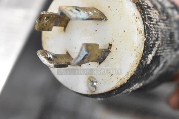 Close-up view of a metal electrical plug for Middleby Marshall CTX DZ33I conveyor pizza oven, showing metal prongs and some wear.