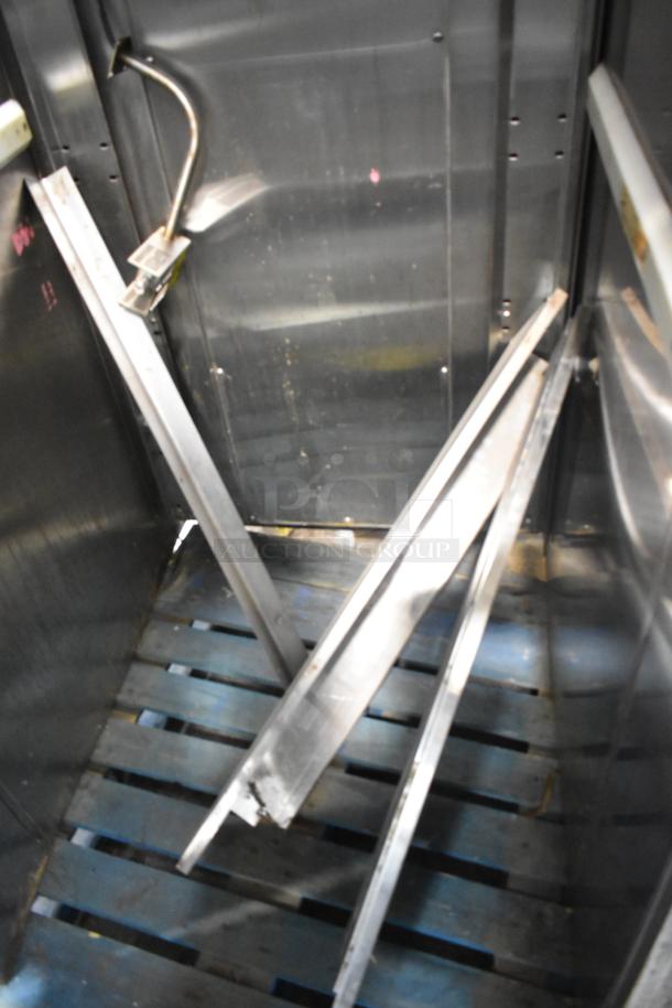 Baxter stainless steel commercial roll-in rack proofer, interior view showing metal racks and panels, requires assembly.