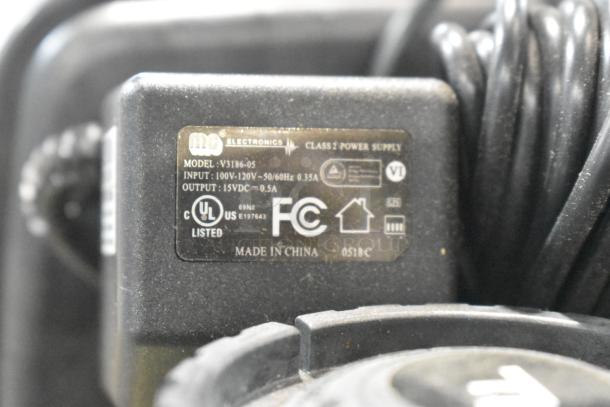 3M water softener tank with MG Electronics power supply, model V3186-05, input 100-120V, output 15VDC, UL and FCC listed.