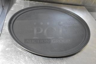 Set of 7 round black food trays in good condition, featuring a textured surface, ideal for commercial use.