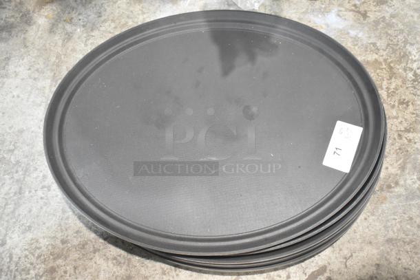 7 black oval food trays, each in decent condition, stacked. A visible tag reads "Lot 71." Sturdy and versatile.