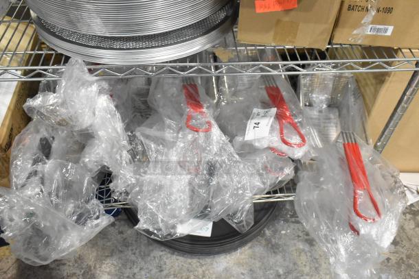 14 new scratch and dent metal fry baskets, including Winco FB-30/FB-05/FB-25. Each wrapped in clear plastic.