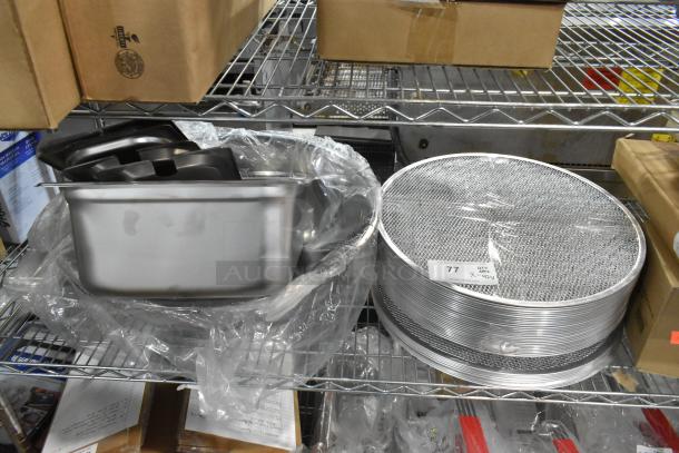 Brand new 42-item lot: metal mesh pizza screens, stainless steel pans, lids, and metal bowl. Packaging intact. Auction item.