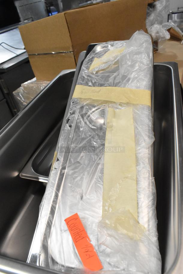 Brand new metal bowl, pizza screens, stainless steel pans, and lids wrapped in plastic with labels. 42 total items.