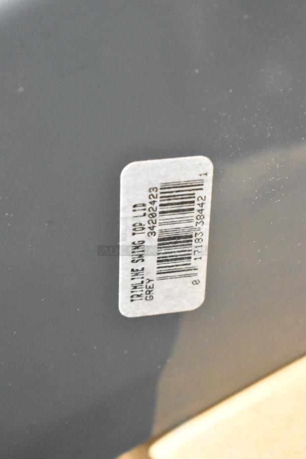 Four brand new Poly Swinging Slim Jim Trash Can Lids in grey. Features a label with barcode and "Trimline Swing 100 Lid Grey."