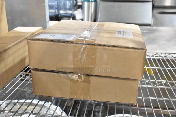 Two sealed cardboard boxes labeled "Rational Install Kit for Water Filter." New condition, stacked on a metal shelf.