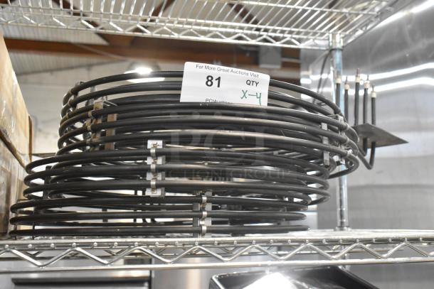 Stack of metal burners with black coils on a shelf, labeled "81, QTY X-4", brand new condition, 4 units included.