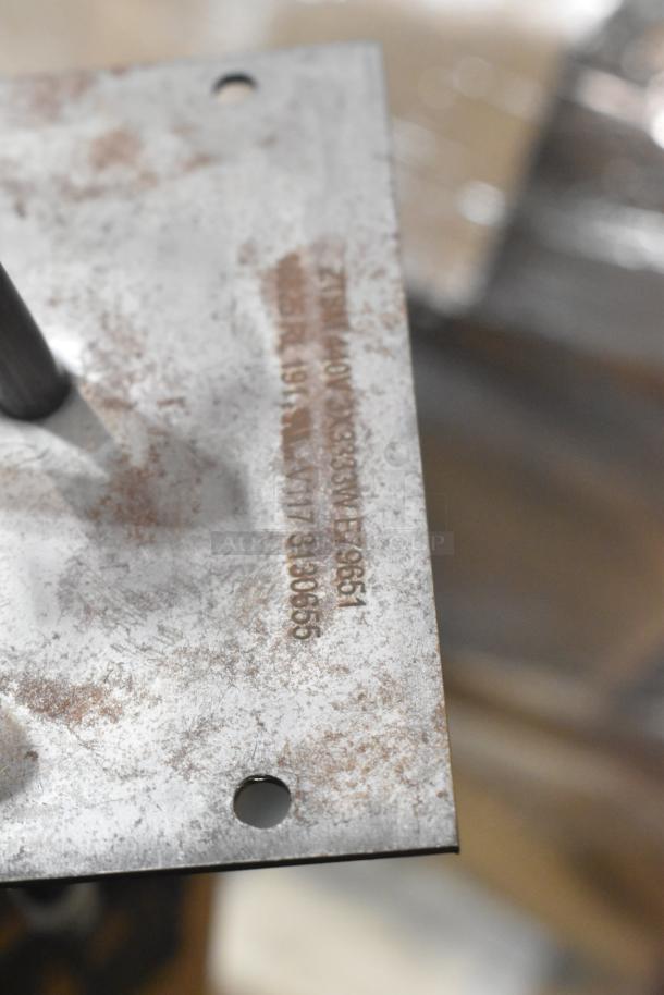 Metal burner component with engraved markings, indicating model and specifications. Part of a lot of 4 brand new items.