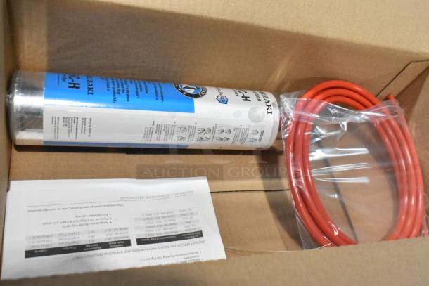 Brand new H9320-51 water filtration system in box, includes filter cartridge and coiled red tubing, with instruction manual.