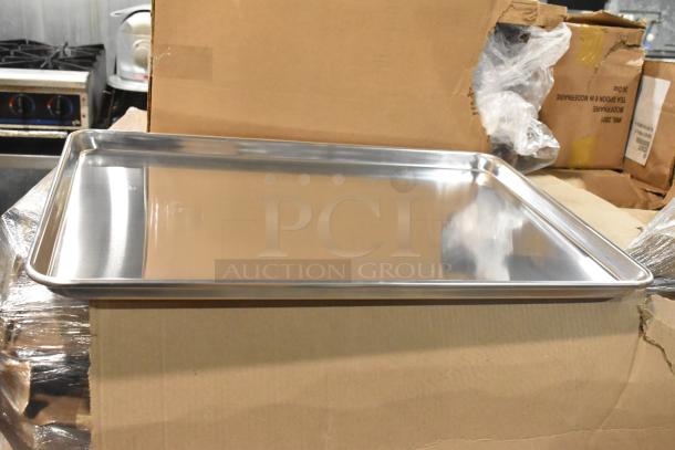 13 brand new Winco ALXP-1826 metal full-size baking pans, shiny condition, stacked on a cardboard box.