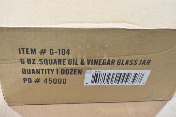 Cardboard box labeled "Item # G-104" with barcode, containing 6 oz oil and vinegar glass jars, quantity one dozen.