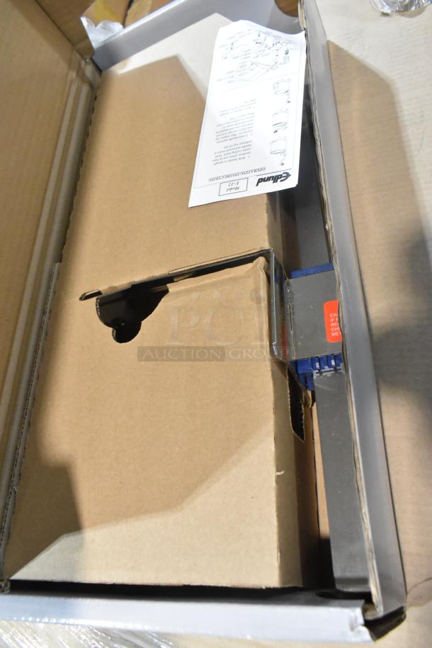 Brand new Edlund U-12 manual can opener in box with instruction manual visible, packed securely.