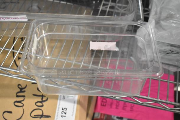20 brand new clear and black poly drop-in bins on a metal shelf, labeled for auction.