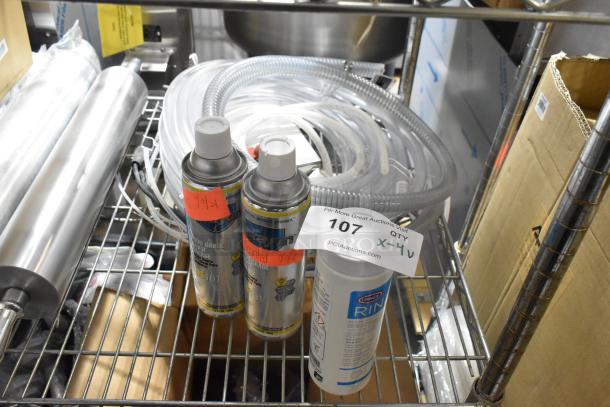 Four brand new items including Urnex Rinza tablets, Sprayon food safe grease, and a hose, displayed on a metal shelf.