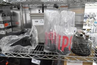 13 brand new items, including a poly pitcher, salt shakers, and espresso machine hopper, on metal shelving.