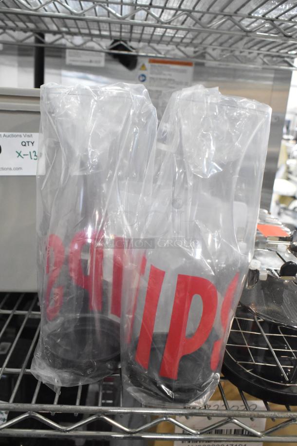 Clear poly pitcher and salt shakers in plastic wrap, new condition, marked for auction, includes espresso machine hopper.