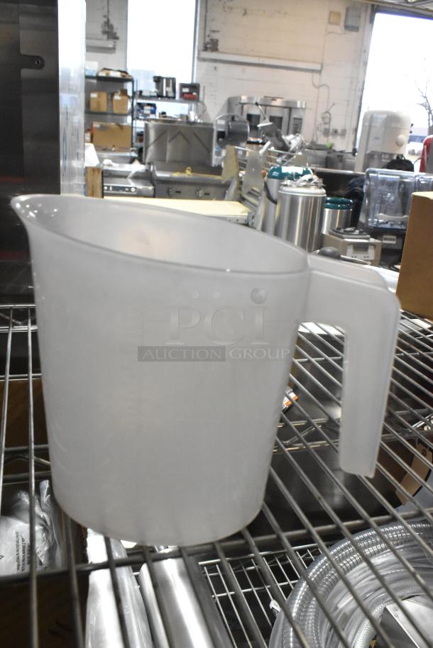 Brand new poly pitcher on metal shelf, featuring a clear design and handle. Part of a 13-item set including kitchen essentials.