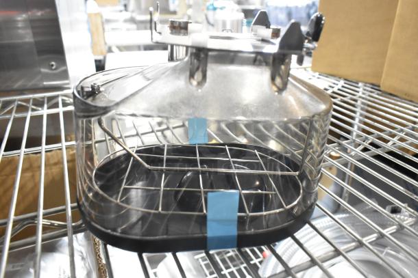 Brand new espresso machine hopper on metal shelf, clear plastic with metal grid design. Part of a 13-item set.