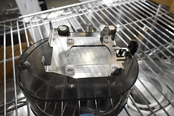 Auction lot featuring a brand new espresso machine hopper on a metal rack.