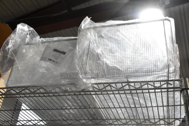 Set of 6 new deep frying baskets, model 60.75.391, wrapped in plastic packaging on a metal shelf, ready for auction.