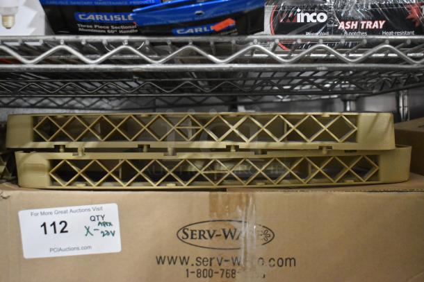 Brand new poly dish caddies stacked on a metal shelf. Includes original packaging. Box labeled with Serv-Ware branding.