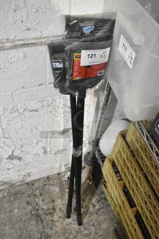 Three brand new brooms in packaging, labeled "121 x 3" for auction. Perfect condition handles and bristles, ready for use.