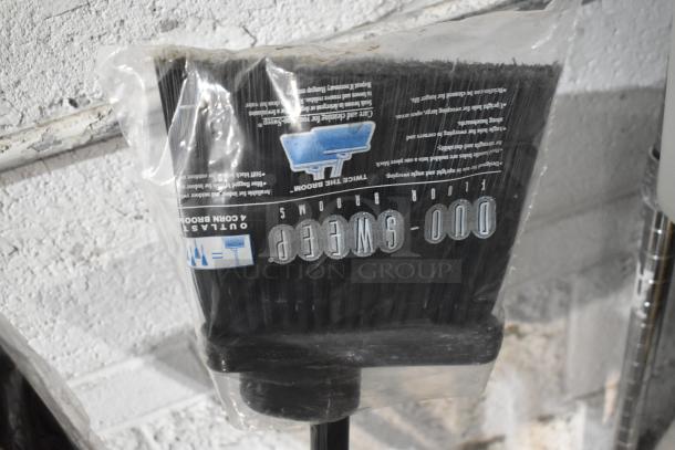 Brand new Outlaws Duro-Sweep 4 Corn Broom in packaging, featuring durable bristles and ergonomic handle.