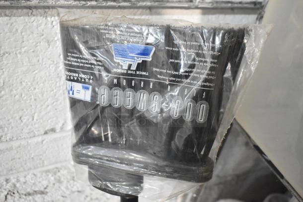 Brand new Duo-Sweep brooms with packaging, featuring durable bristles. Marked as "Outlasts Corn Brooms."