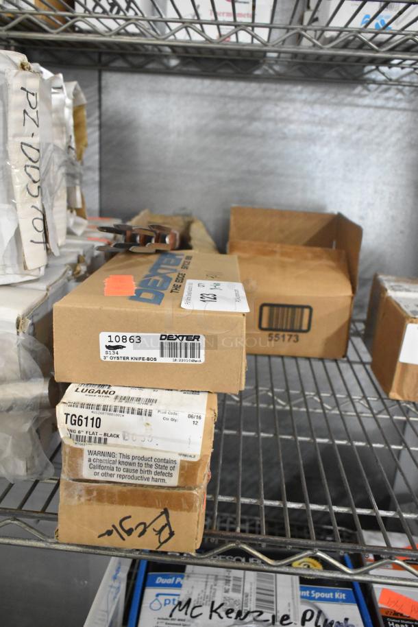 Boxes of Dexter 3" oyster knives, Cambro TG6110 tongs, Update steak forks, and Winco SP73DS drainer shelves on a shelf. Items are new.