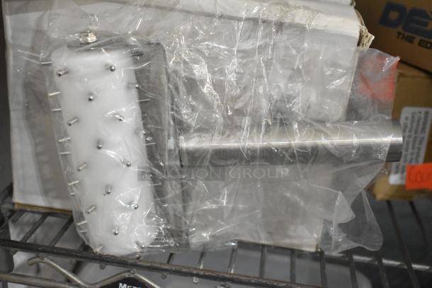 Brand new dough docker, white and stainless steel, in original packaging, showcased on a metal shelf. Auction includes 16 units.