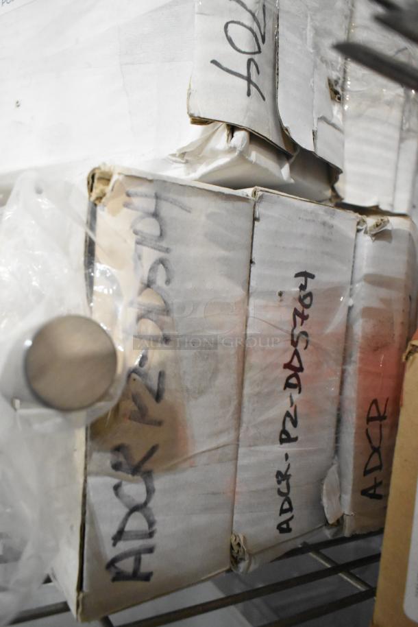 Boxes marked "ADCR PZ-DD5764" containing brand new dough dockers, 16 included, stacked and sealed for auction.