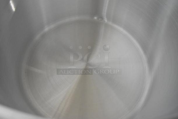 Brand new metal stock pot, interior view, including Winco ASHP-26. Ideal for bulk cooking.
