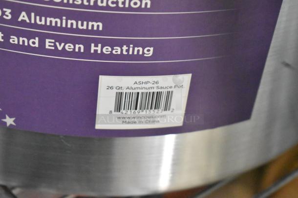 Brand new 26 Qt. Winco ASHP-26 aluminum sauce pot, with barcode and label indicating it's made in China.
