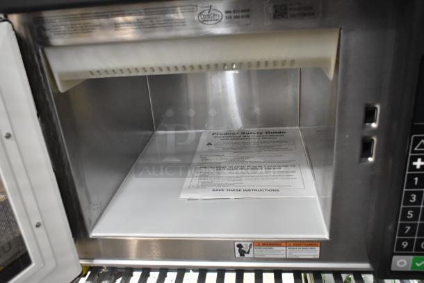 Brand new 2025 Amana RC17S2 heavy-duty stainless steel commercial microwave oven with push-button controls, interior view.