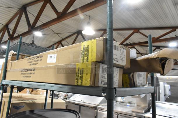 Four Hatco GRNM-42 Glo-Ray Infrared Strip Heaters in boxes on a shelf, labeled as new.