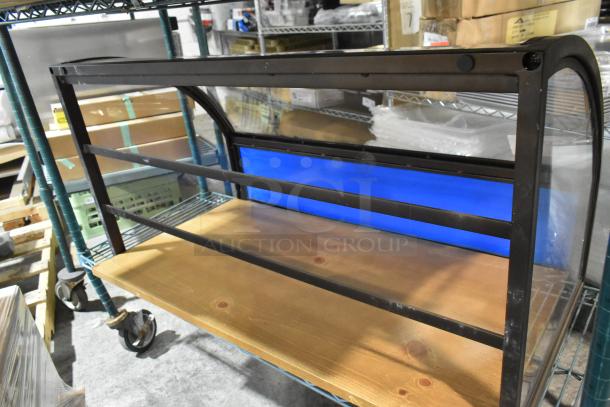 Countertop dry merchandising display case, black metal frame, blue back panel, wooden base, excellent condition.