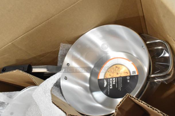 Box containing new Wear-Ever 10376861 metal skillets and Vollrath 382170 7-quart sauce pans, with packaging labels visible.